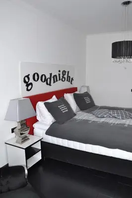 a bedroom with two beds and a sign on the wall at Fletcher Hotel Restaurant Marijke in Bergen