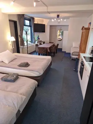 a hotel room with two beds and a table at Duin-Vliet - Free parking in Bentveld