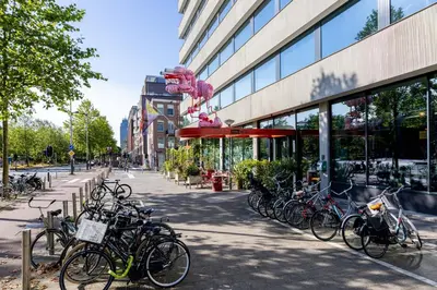 a bunch of bikes parked in front of a building at Volkshotel in Amsterdam