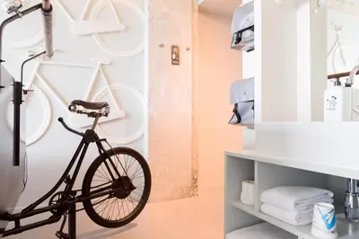 a bike in a bathroom with a bike rack at Volkshotel in Amsterdam