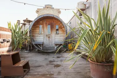 a small wooden building with a sign that says surfing at Volkshotel in Amsterdam