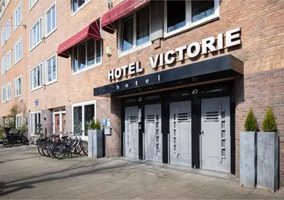 a hotel sign on the side of a brick building at Hotel Victorie in Amsterdam