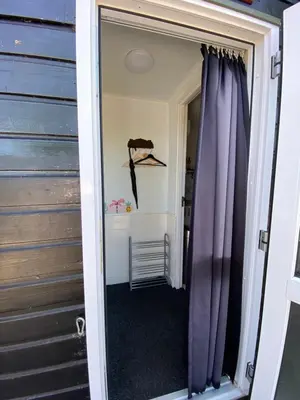 a door leading into a room with purple curtains at La Luna - Danny in Heerhugowaard