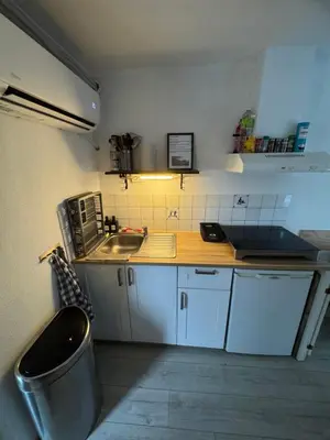 a small kitchen with a sink and a counter at La Luna - Danny in Heerhugowaard