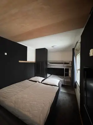 a bedroom with two beds and a bunk bed at La Luna - Danny in Heerhugowaard