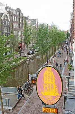 a sign for a hotel next to a river at Hotel Torenzicht in Amsterdam