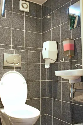 a bathroom with a toilet and a sink at Hotel Torenzicht in Amsterdam