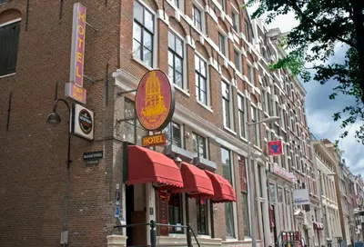 a brick building with a sign on the side of it at Hotel Torenzicht in Amsterdam