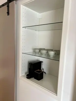 a shelf with bowls and a toaster on it at Surla Houseboat 