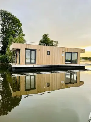 a house sitting on top of a body of water at Surla Houseboat 