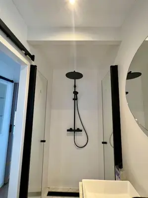 a room with a mirror and a light on the wall at Surla Houseboat 