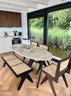 a kitchen with a table and chairs in a room at Surla Houseboat 