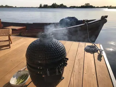 a pot on a table on a boat on the water at Surla houseboat 