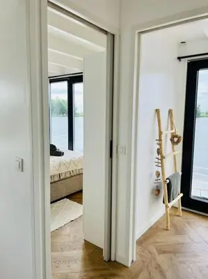 a room with a door leading to a bedroom at Surla houseboat 