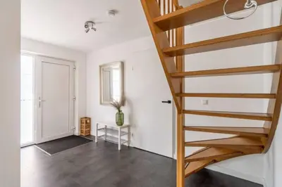 a stairway in a white room with a hallway at Modern Luxury villa in Zeewolde