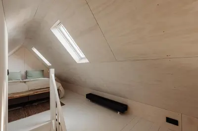a small bedroom with a bed in a attic at Studio Verver in Bergen