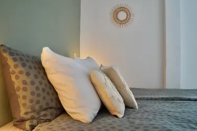 a pile of pillows sitting on top of a bed at Vakantiehuis 't Hofje nabij dorpscentrum en strand in Castricum