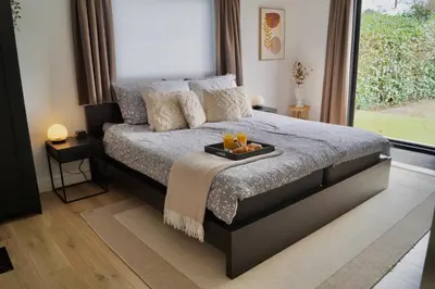 a bedroom with a bed with a tray of oranges on it at Vakantiehuis 't Hofje nabij dorpscentrum en strand in Castricum