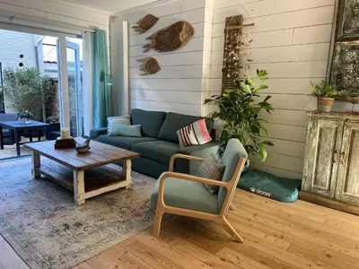 a living room with a couch and a coffee table at The Coast Beach House in Egmond aan Zee