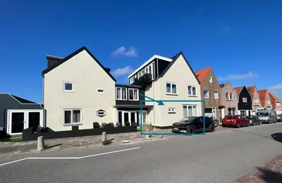 a row of houses on the side of a street at The Coast Beach House in Egmond aan Zee