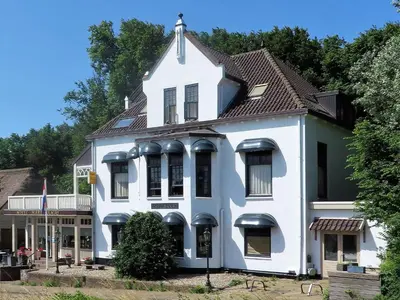 a white house with a brown roof at Mare Sanat in Wijk aan Zee