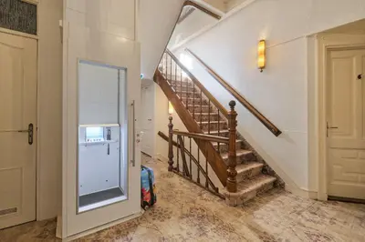 a hallway with a stairway with a door and a stair case at Mare Sanat in Wijk aan Zee