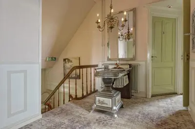 a hallway with a table and a mirror and stairs at Mare Sanat in Wijk aan Zee