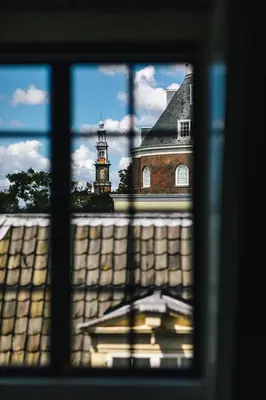 a view from a window of a building with a clock tower at The Dylan Amsterdam - The Leading Hotels of the World in Amsterdam