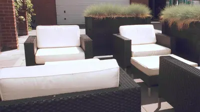 a group of white chairs sitting on a patio at Luxe woning ‘BARNS’ Castricum aan Zee + airco + parkeren in Castricum