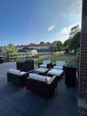 a group of chairs and tables on a patio at Luxe woning ‘BARNS’ Castricum aan Zee + airco + parkeren in Castricum
