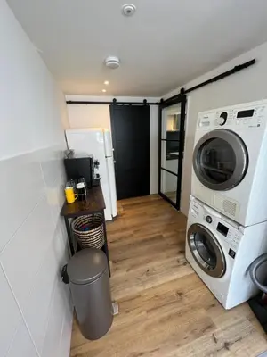 a laundry room with a washer and dryer in a house at Luxe woning ‘BARNS’ Castricum aan Zee + airco + parkeren in Castricum