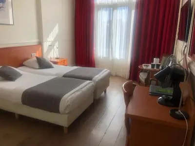 a hotel room with a bed and a desk with a desk at Delta Hotel City Center in Amsterdam