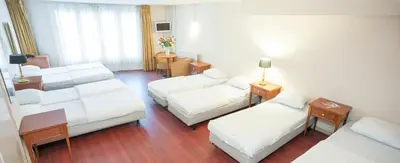 a living room with white furniture in a hotel room at Delta Hotel City Center in Amsterdam