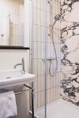 a bathroom with a shower and a sink at Boutique hotel Villa Trompenberg in Hilversum