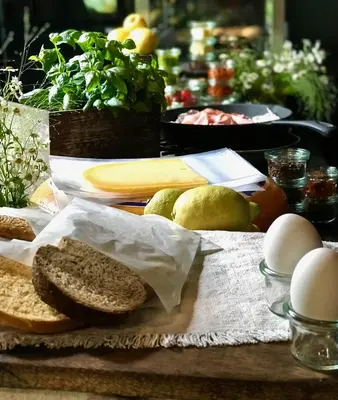 a table with bread and eggs and other foods at Boutique hotel Villa Trompenberg in Hilversum