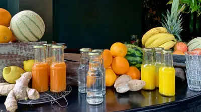 a bunch of bottles of juice and fruit on a table at Boutique hotel Villa Trompenberg in Hilversum