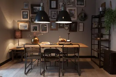 a dining room with a table and chairs and pictures on the wall at Mother Goose Hotel in Utrecht