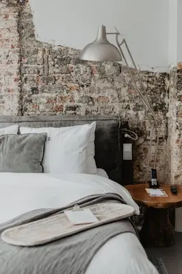 a bedroom with a bed and a lamp on a table at Mother Goose Hotel in Utrecht