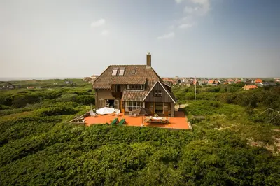 an aerial view of a house on a hill at Villa de Duintop in Bergen aan Zee