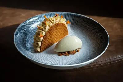 a blue plate with a piece of cake and ice cream at Kasteel Kerckebosch in Zeist