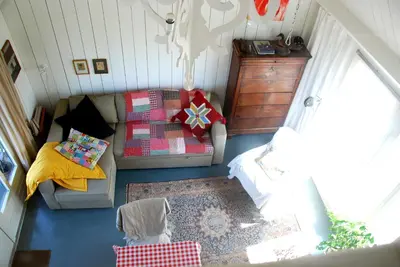 a living room with a couch and a table at Bed In Waterland in Broek in Waterland