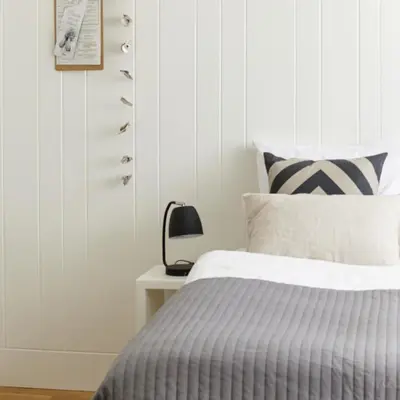 a bedroom with a bed and a side table at Hotel Zonne in Noordwijk aan Zee