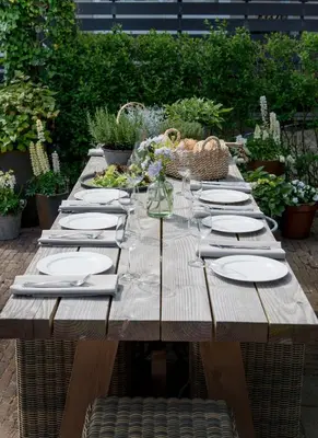 a wooden table with plates and napkins on it at Hotel Zonne in Noordwijk aan Zee