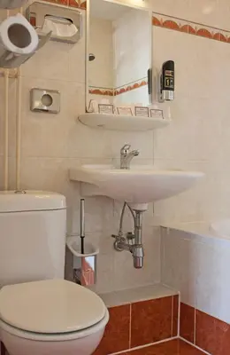 a bathroom with a white toilet and a sink at Hotel Prins Hendrik in Amsterdam