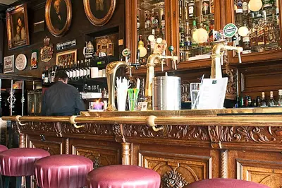 a man sitting at a bar in a pub at Hotel Prins Hendrik in Amsterdam