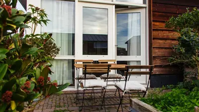a table and chairs in front of a window at The marine apartment near Amsterdam by Weltevreden Experience in Kortenhoef