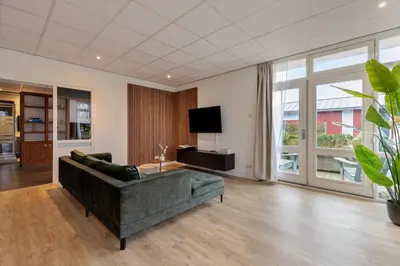 a living room with a couch and a flat screen tv at The marine apartment near Amsterdam by Weltevreden Experience in Kortenhoef