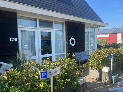 a house with a parking sign in front of it at The marine apartment near Amsterdam by Weltevreden Experience in Kortenhoef