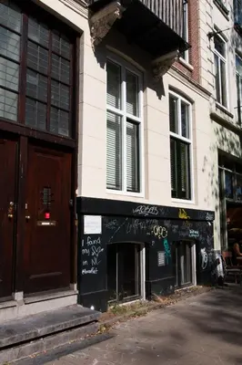 a store with graffiti on the side of a building at B&B Midtown Amsterdam suites in Amsterdam