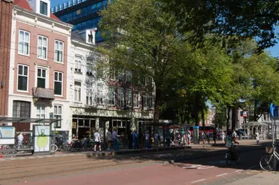 a group of people walking on a city street at B&B Midtown Amsterdam suites in Amsterdam